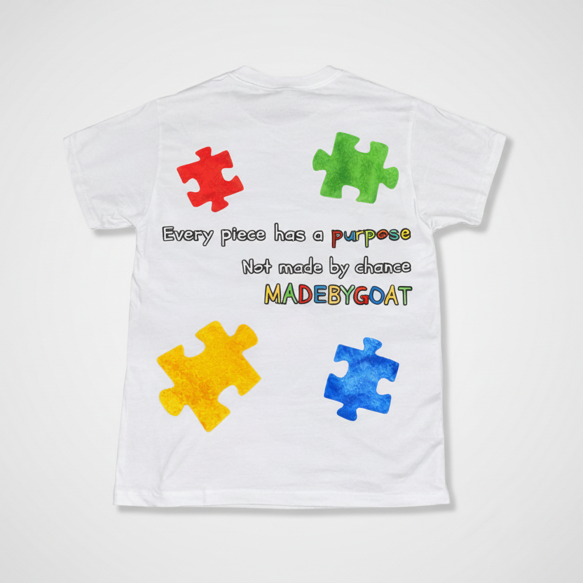 White t-shirt with colorful puzzle pieces and text on a white background