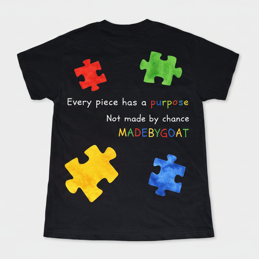 Black t-shirt with colorful puzzle pieces and text on a white background